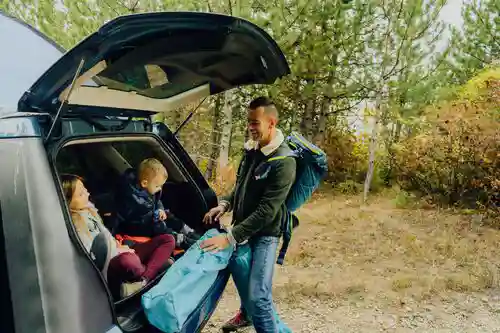 family unloading camping equipment
